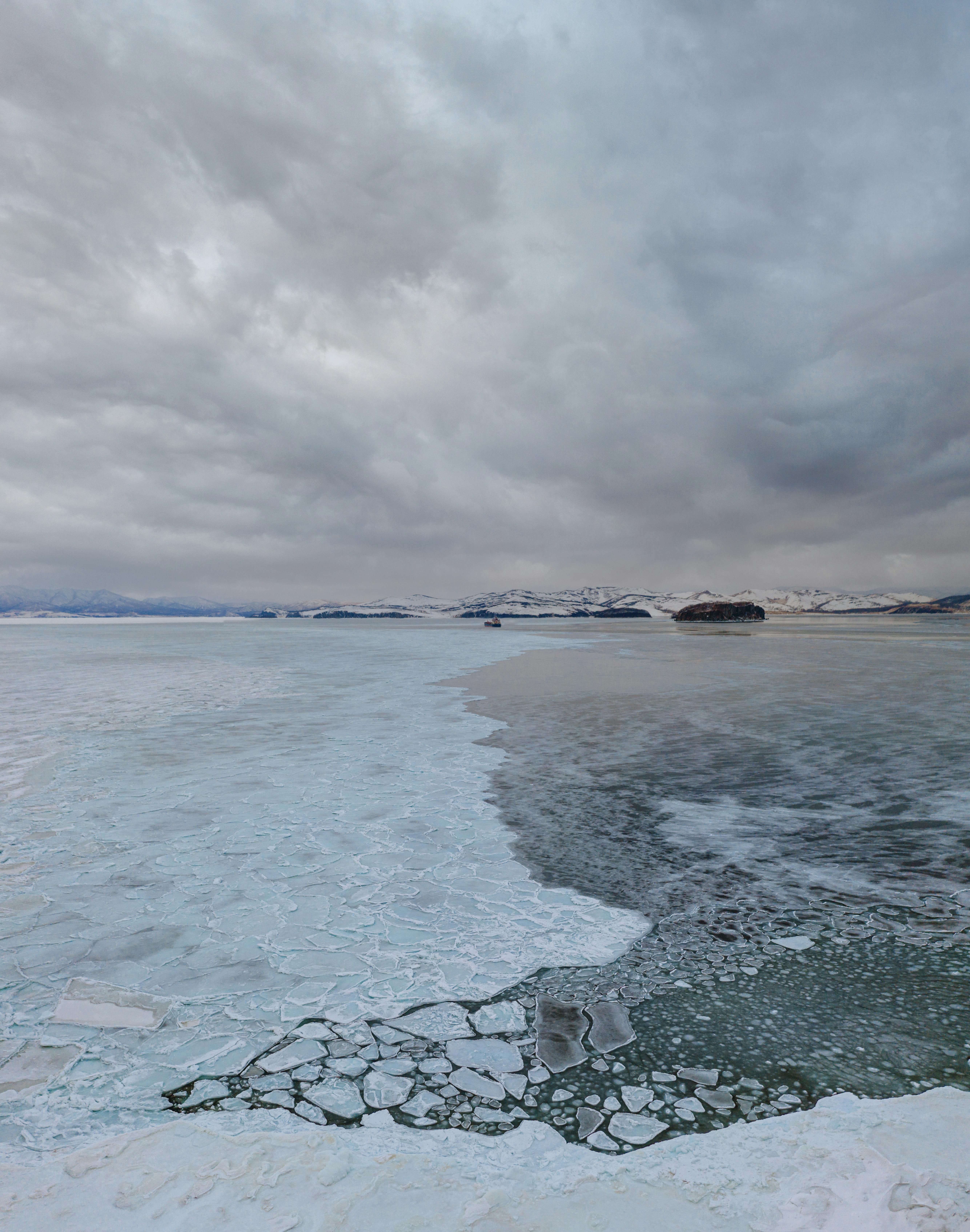 body of water under cloudy sky