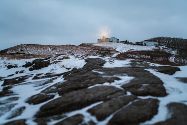 A Lighthouse On Snow Covered Ground