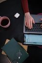 Person Using Macbook Pro on Black Table