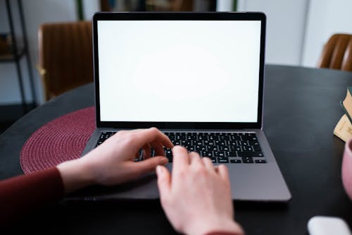 A Person Typing on the Laptop