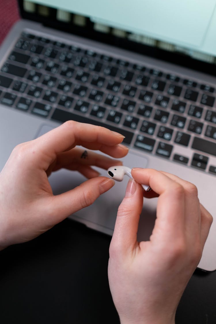 A Person Holding Wireless Earphone