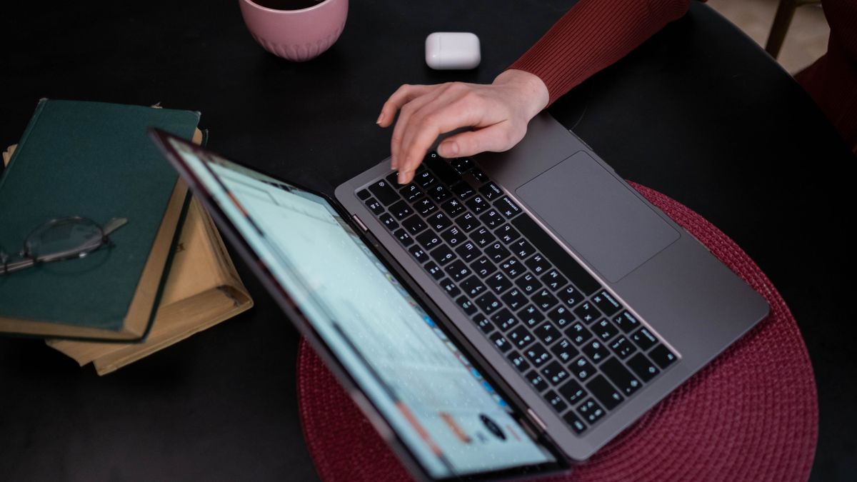 A person comparing hotel prices on a laptop while planning a trip in 2026