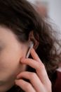 Woman Holding White Apple Earpods