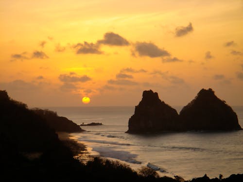 Silhouette of Rock Formations on the Beach during Sunset