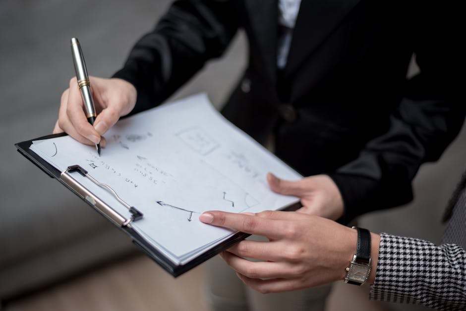 Two people in a professional meeting with one person taking notes - retirement tax planning advisor near me