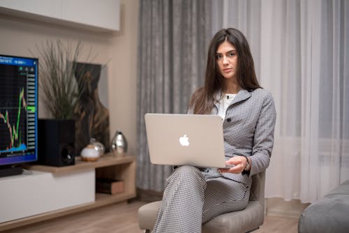 A Woman in Plaid Blazer Using a Laptop