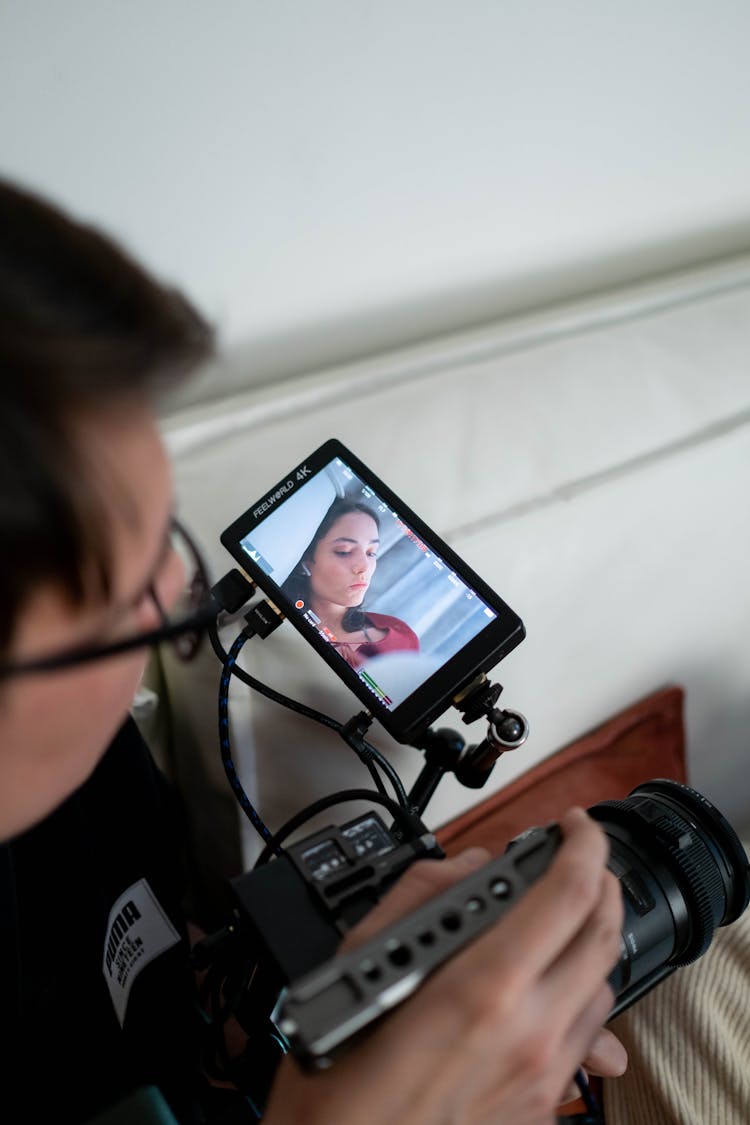 A Videographer Recording A Woman Using A Video Camera