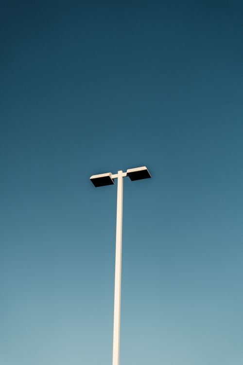 Free A modern street light captured against a clear blue sky, showcasing minimalist design. Stock Photo