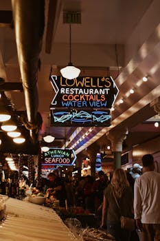 Diners and neon signs create a lively atmosphere at Pike Place Market, Seattle.