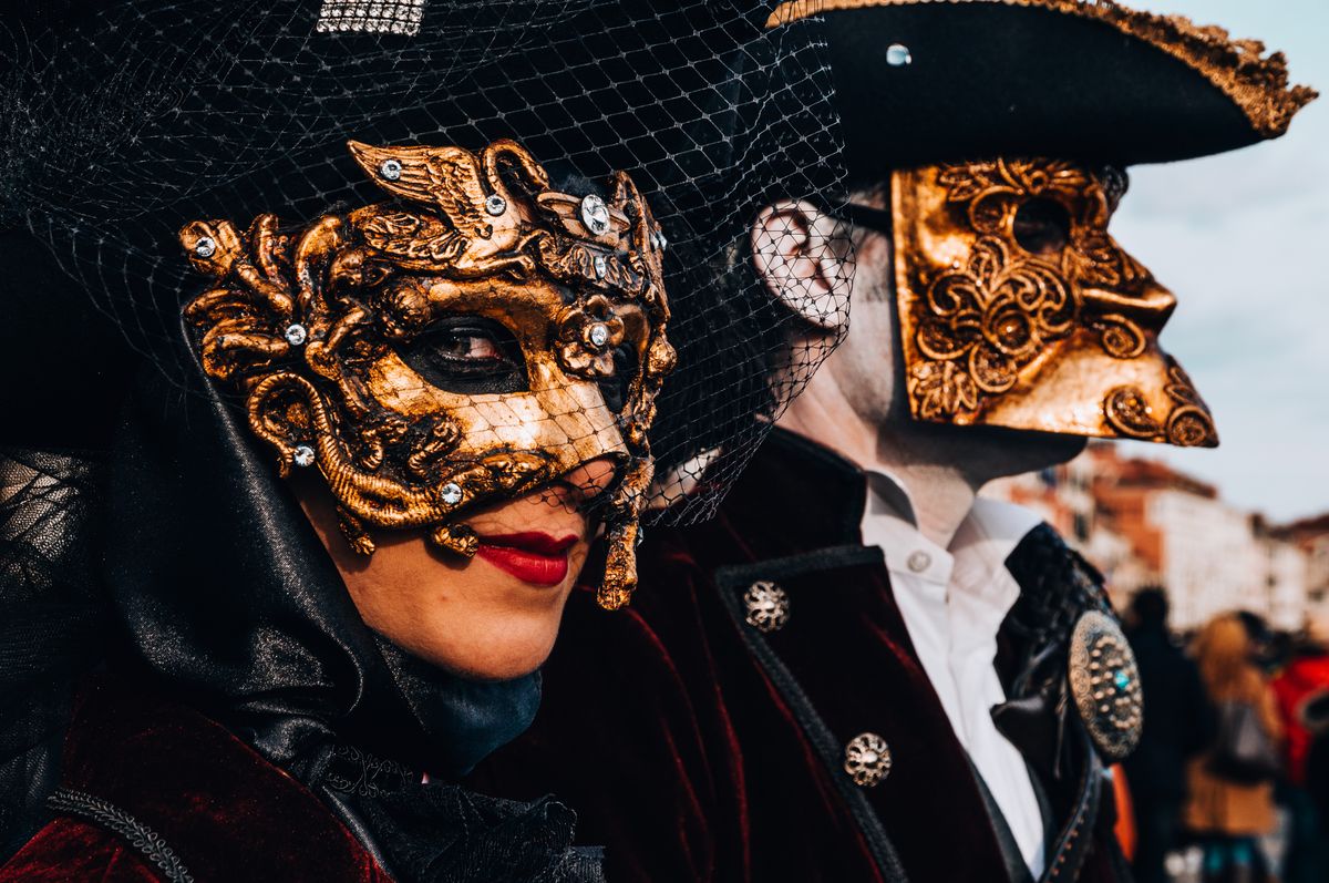 Masquerade ball New Year's Eve party with gold masks