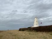 White Lighthouse Under the Cloudy Sky