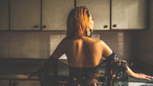 Free Back View of a Sexy Woman in the Kitchen Counter Stock Photo