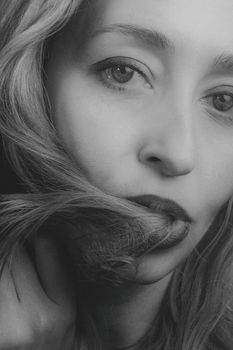 Striking grayscale portrait capturing the serene expression of a woman.