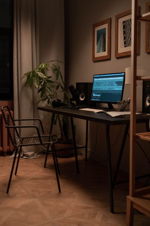Free A cozy home recording studio with a monitor, speakers, and a stylish chair. Stock Photo