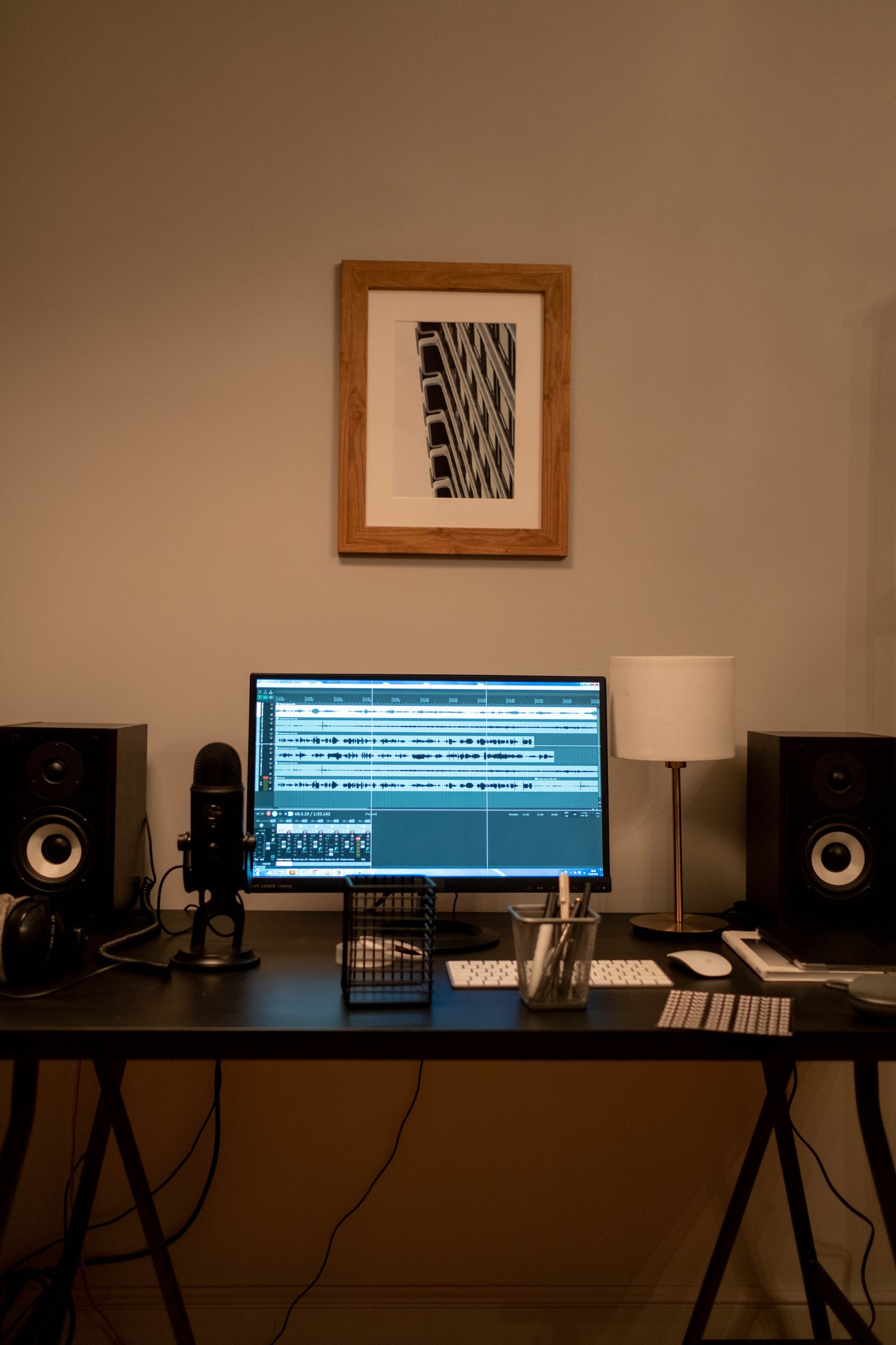 Audio software displayed on a desk monitor with speakers nearby.