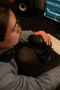 A sound engineer adjusting a microphone in a recording studio.