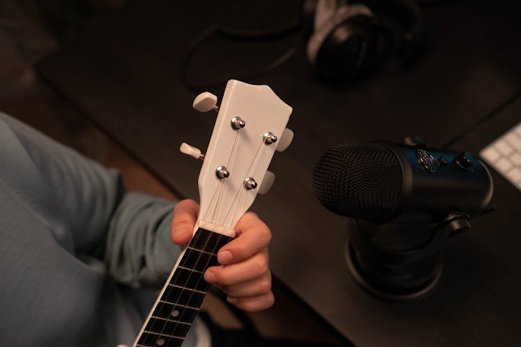 Person Playing Guitar In Grayscale Photography