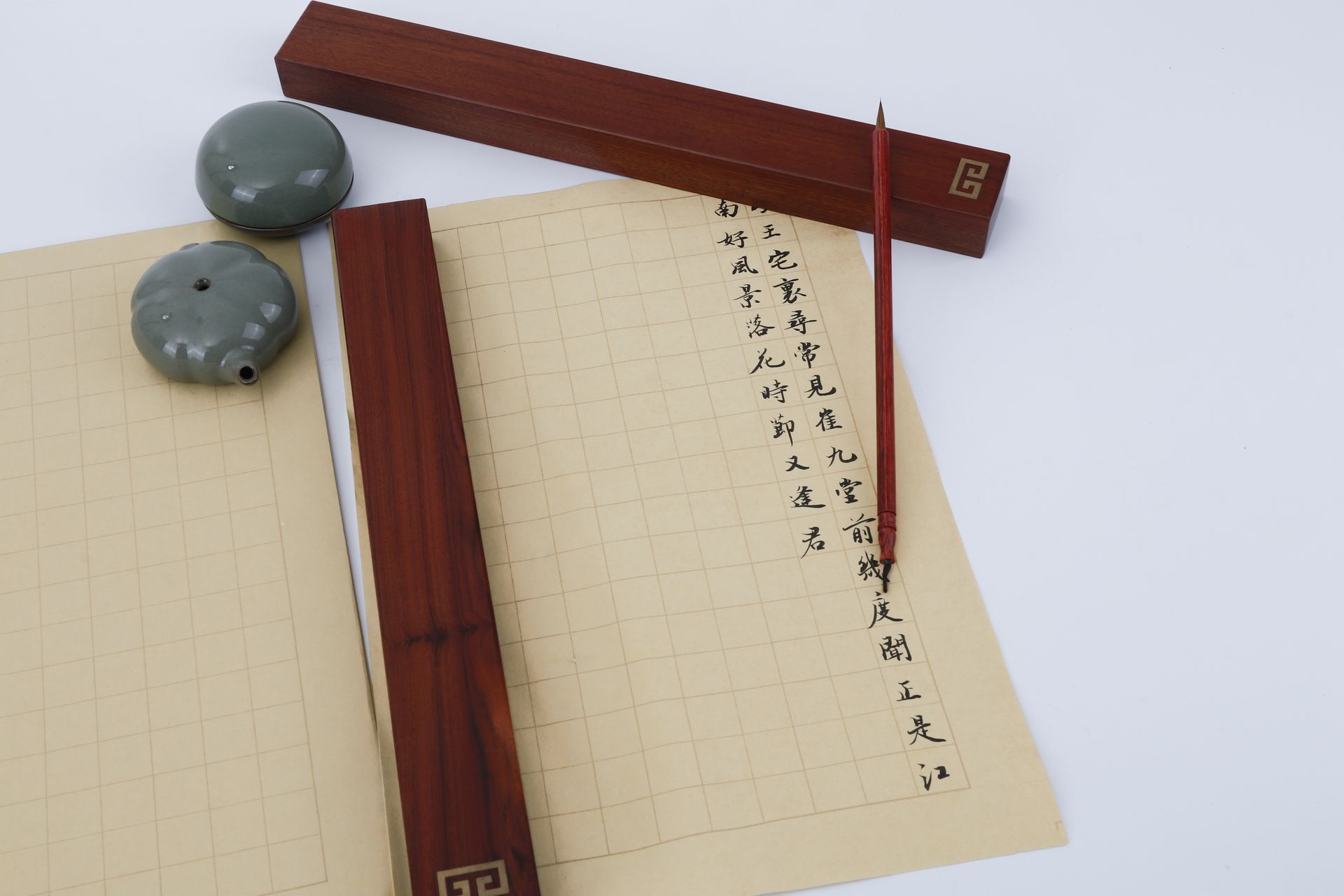 A traditional Chinese calligraphy setup with ink, brush, and paper.