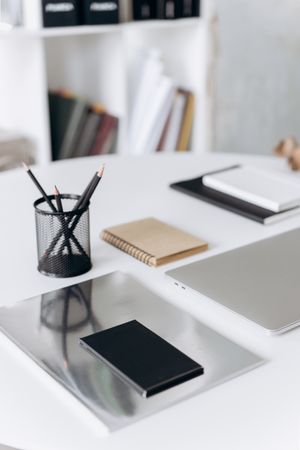 Organised desk with notebooks and pencils — photo by Mikhail Nilov on Pexels