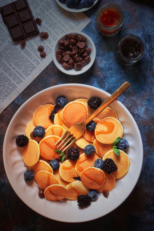 Free Delicious pancakes with syrup, blueberries, and blackberries in a top-down view. Stock Photo