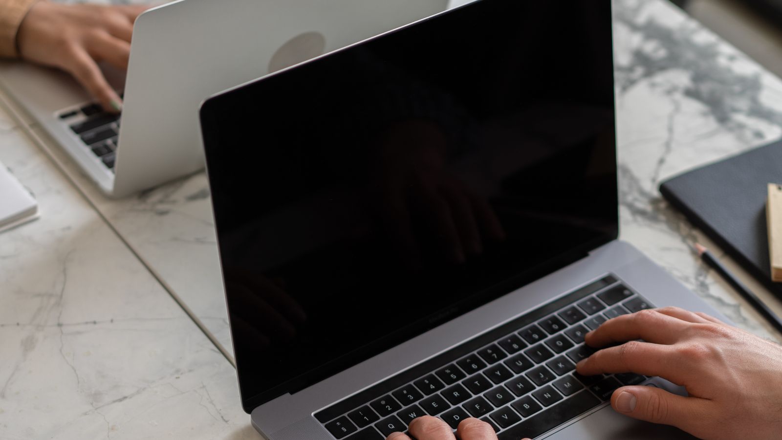 Person working on a laptop at a desk
