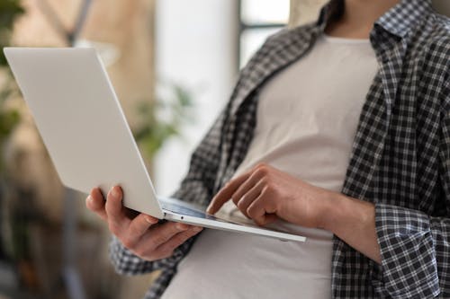 Close-Up Shot of a Person Holding a Laptop