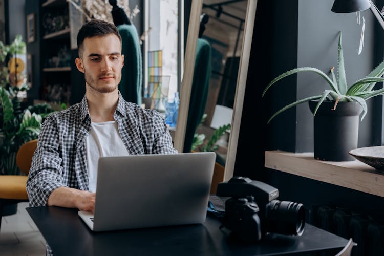 Man In Plaid Shirt Using Laptop