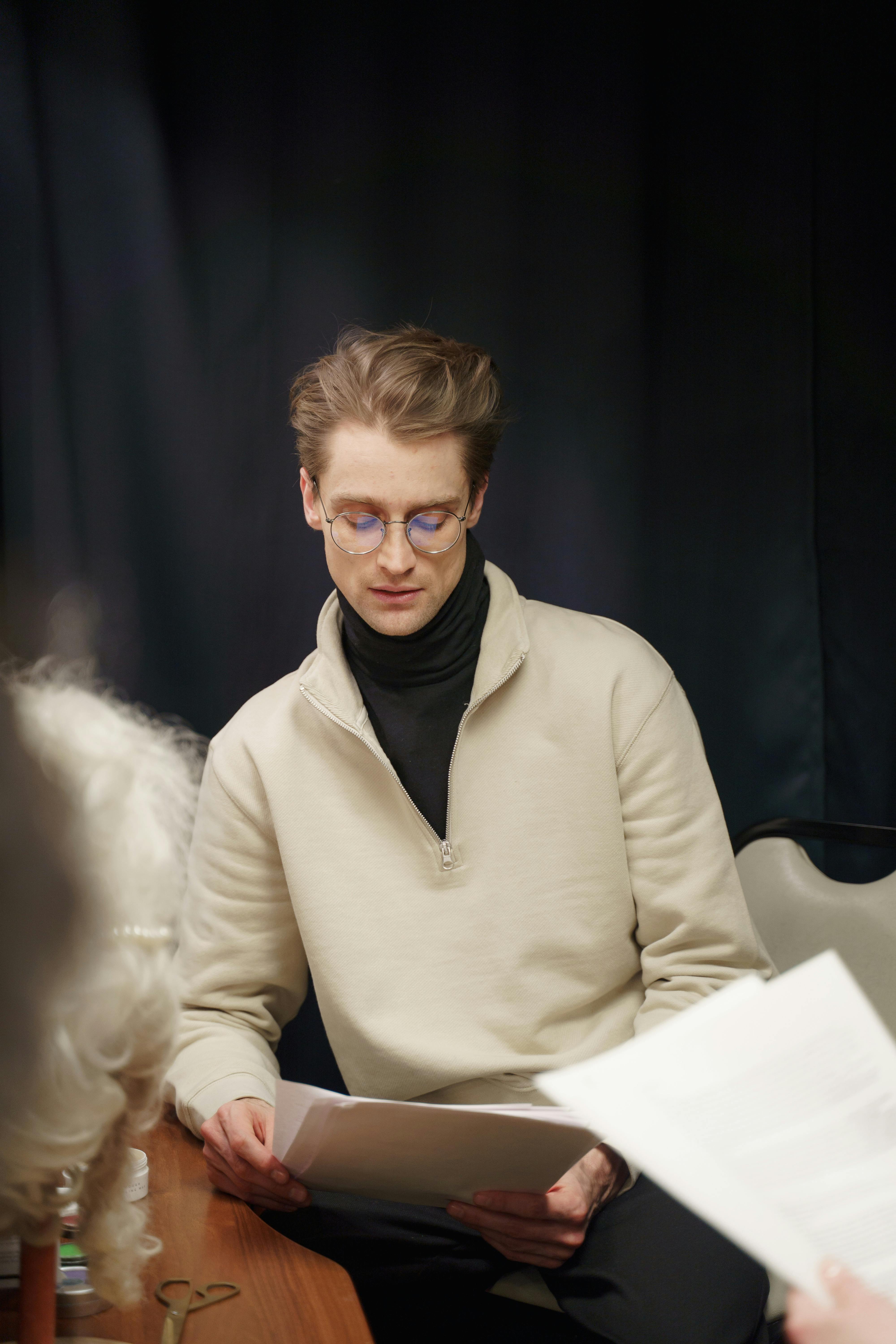 man sitting and reading the script