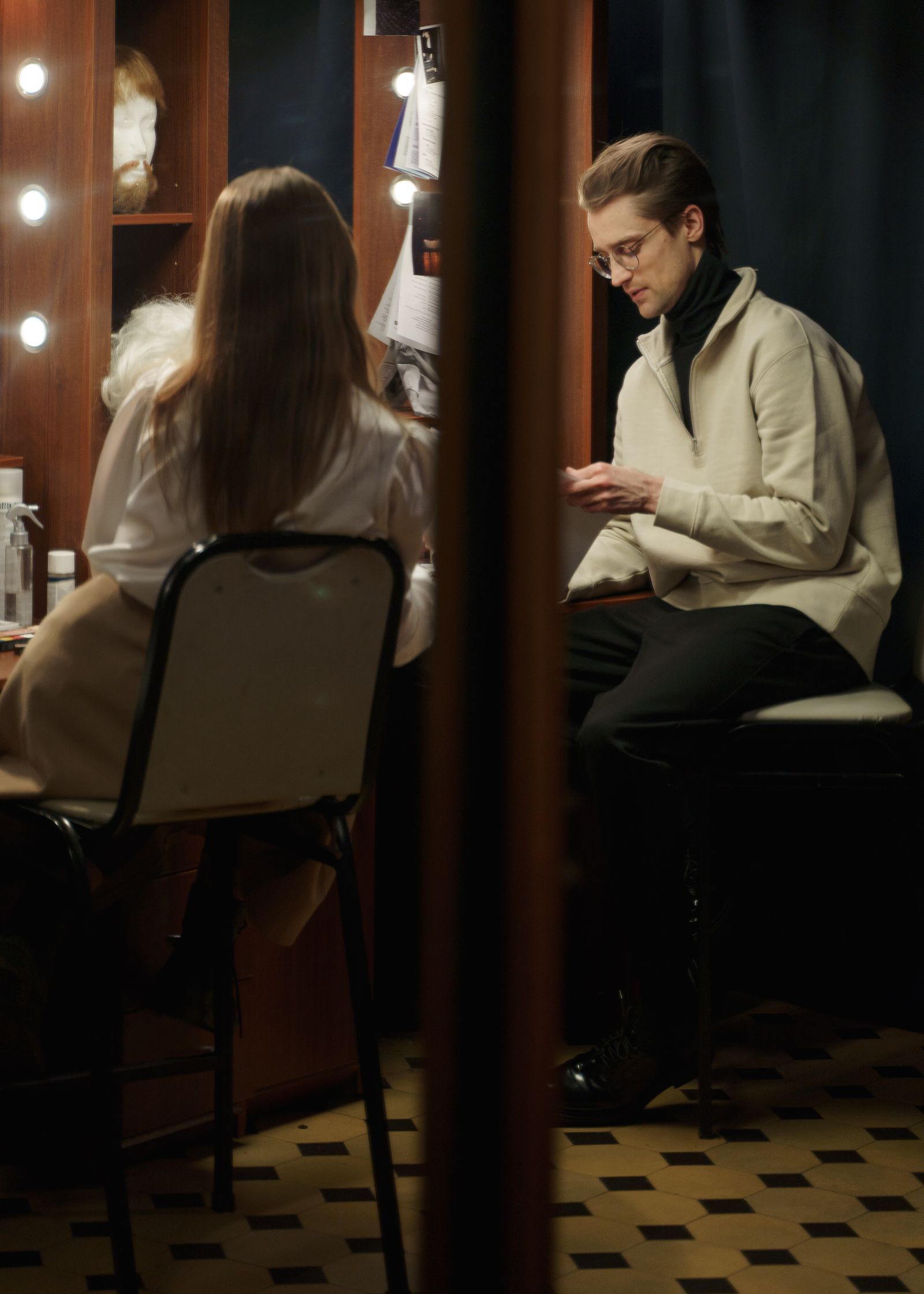 Two performers preparing in a backstage dressing room
