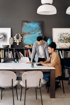 Two colleagues discussing a project in a stylish and modern office environment.