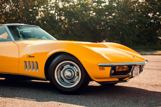 Retro yellow Chevrolet Corvette Stingray parked outdoors with a vintage feel.