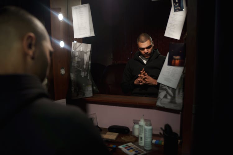 Reflection Of Man In Black Suit Jacket In The Mirror