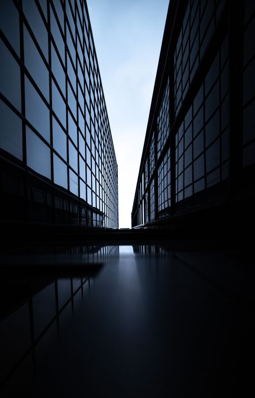 Free Dramatic view between two modern skyscrapers with glass facades, emphasizing symmetry. Stock Photo