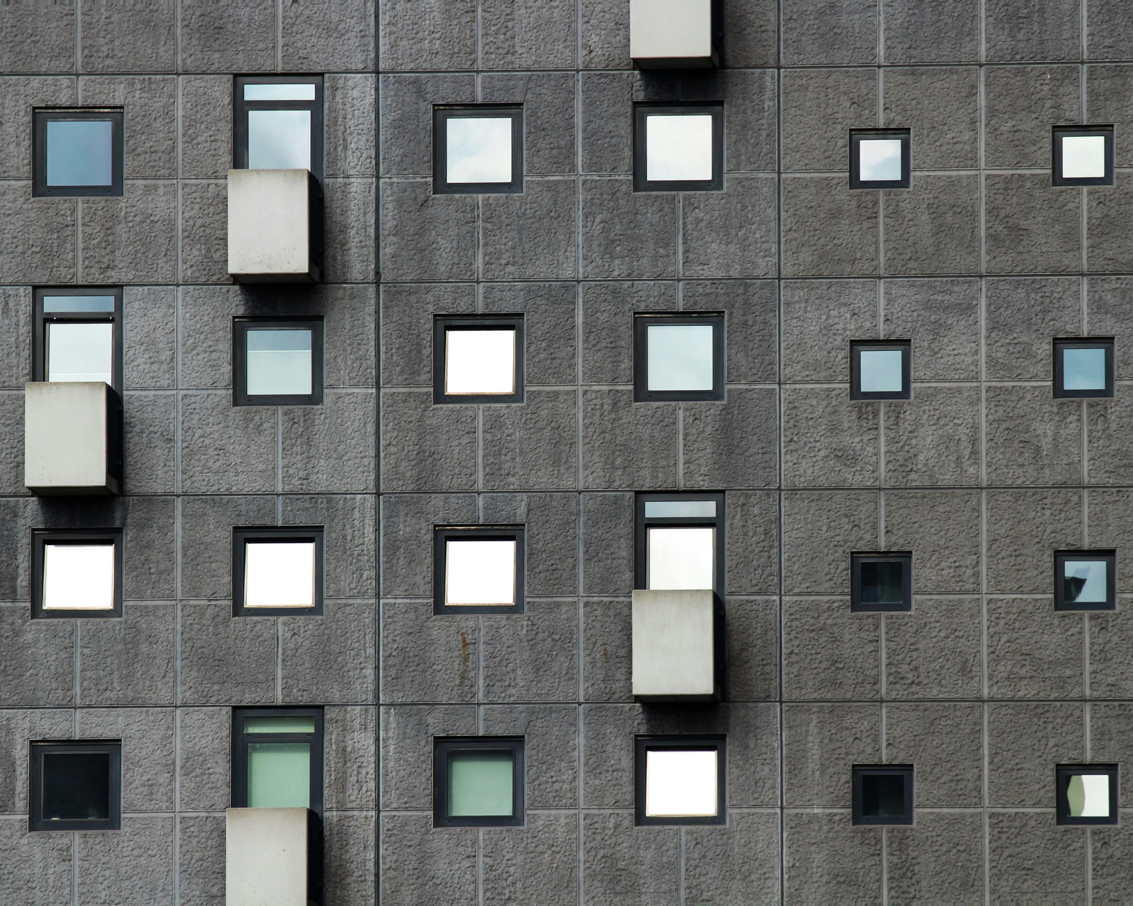 Windows and Balconies of an Apartment Building · Free Stock Photo