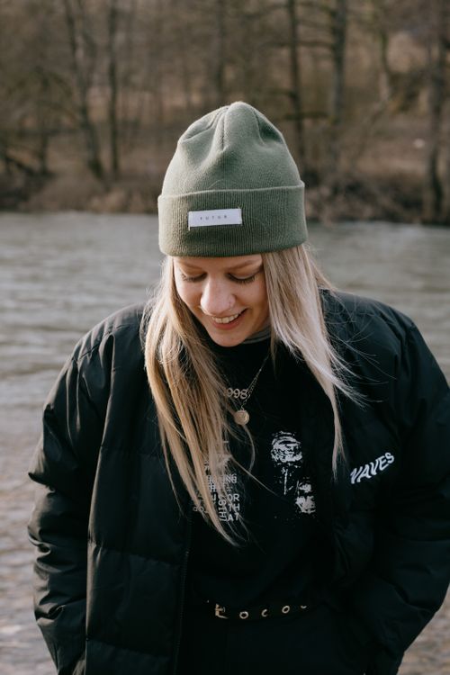 Free Woman in winter clothing by a riverside in Durbuy, Belgium. Stock Photo