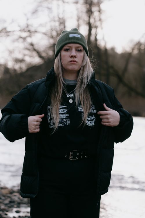 Free Portrait of a young woman in winter fashion by a river in Durbuy, Belgium. Stock Photo