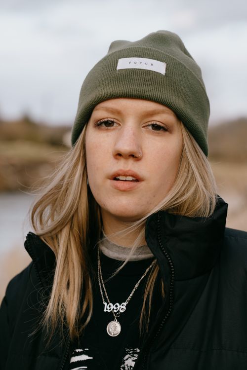 Free Close-up portrait of a woman wearing a beanie and jacket, outdoors in Durbuy, Belgium. Stock Photo