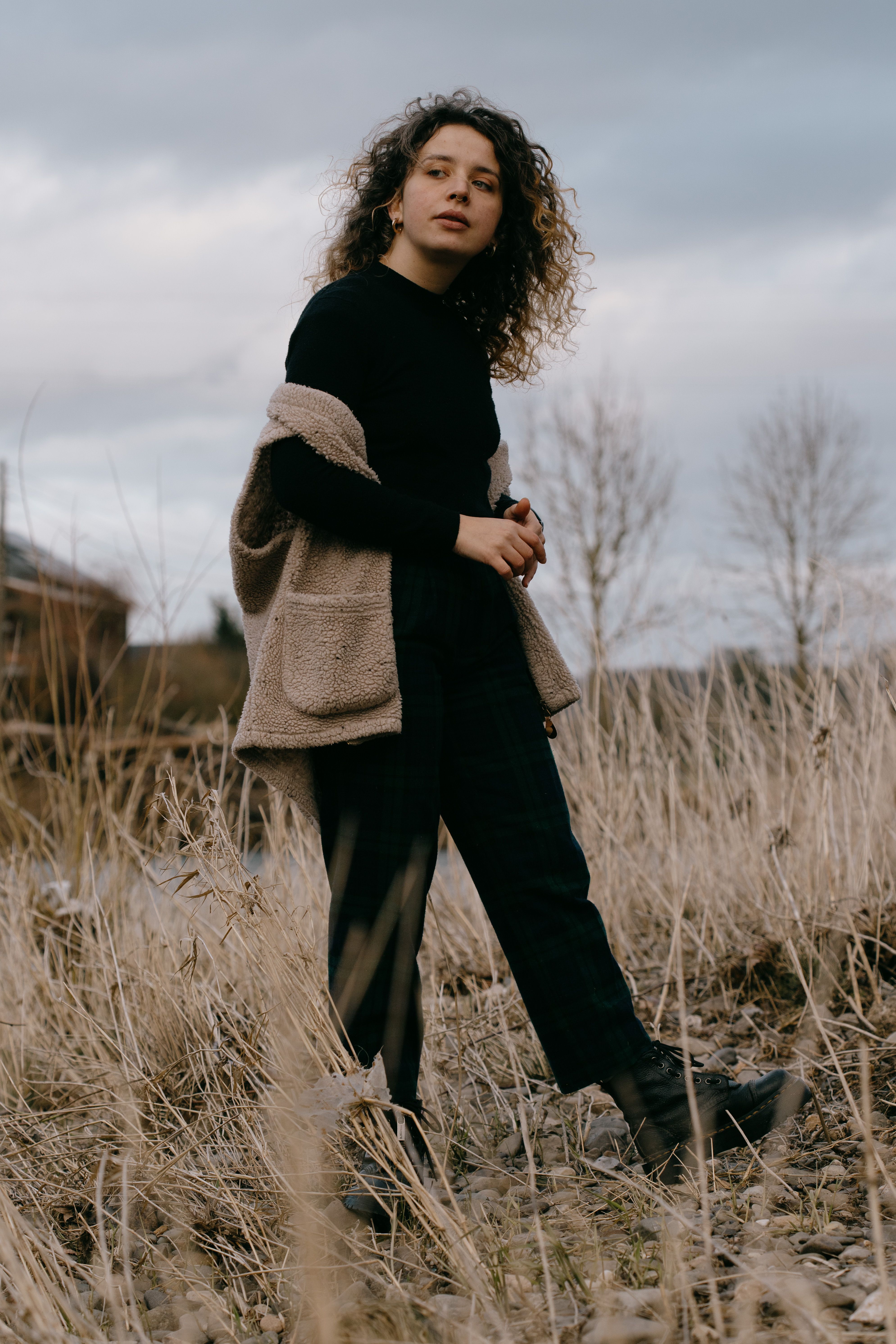 Woman in Black Jacket Standing on Grass Field · Free Stock Photo