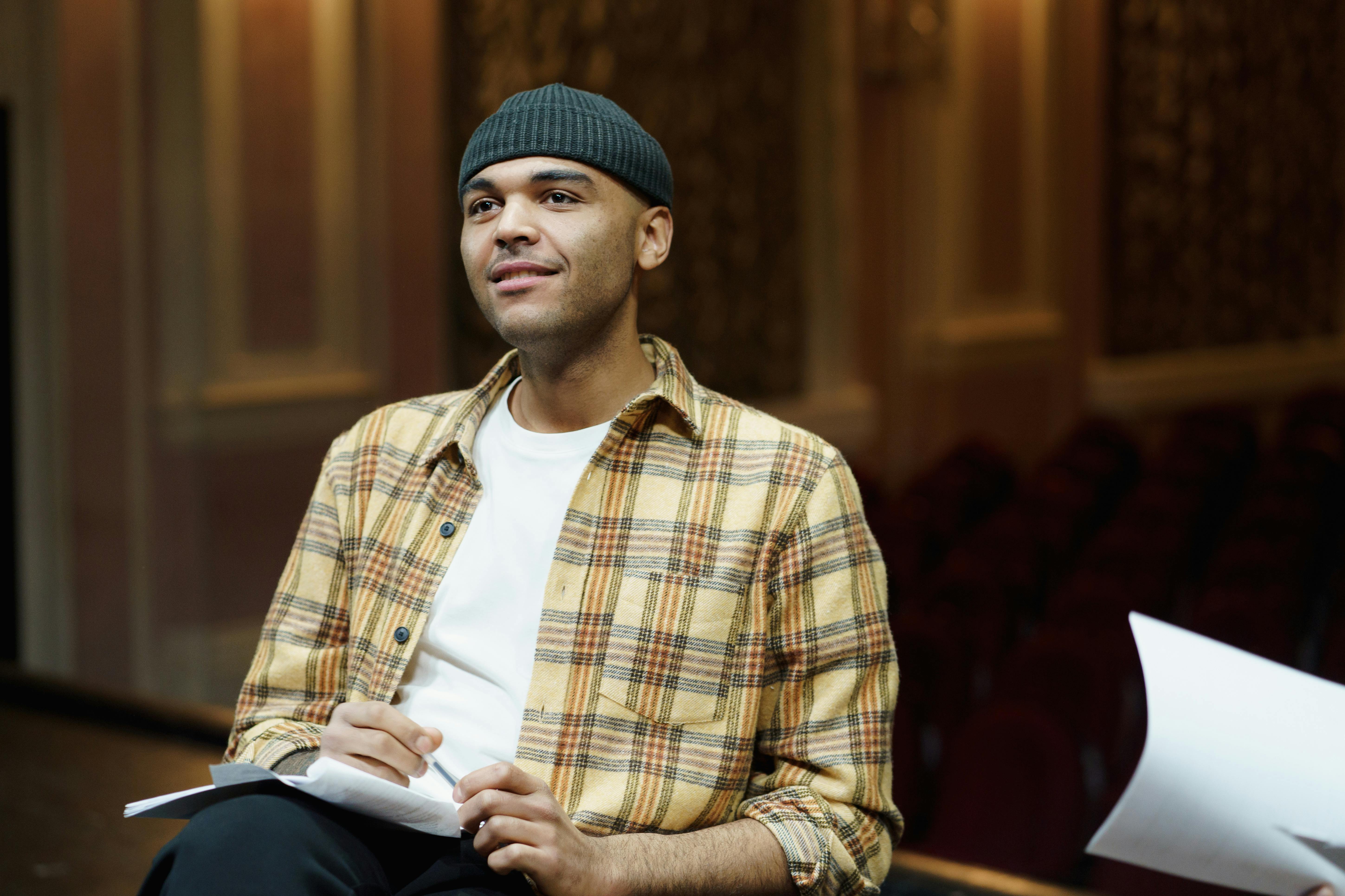 man wearing a plaid shirt and knit cap