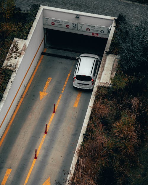 White Car About to Enter a Parking a Lot