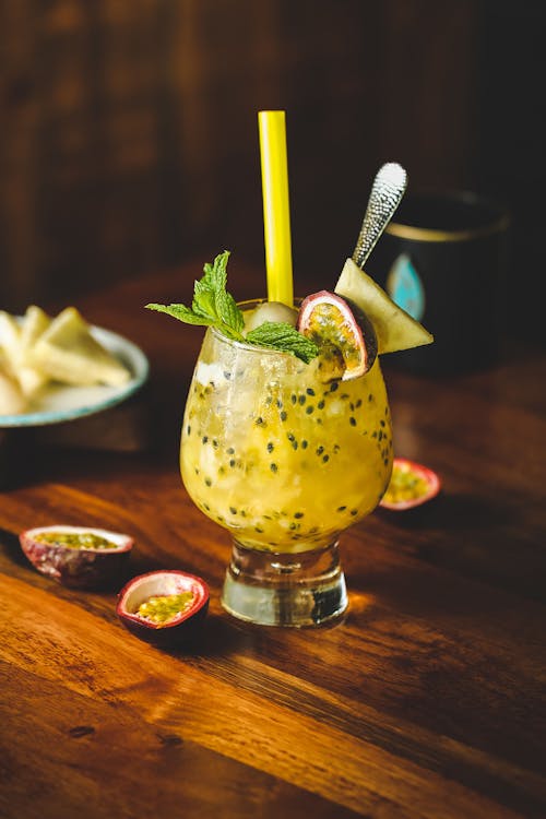 Glass with cocktail with passion fruits and mint