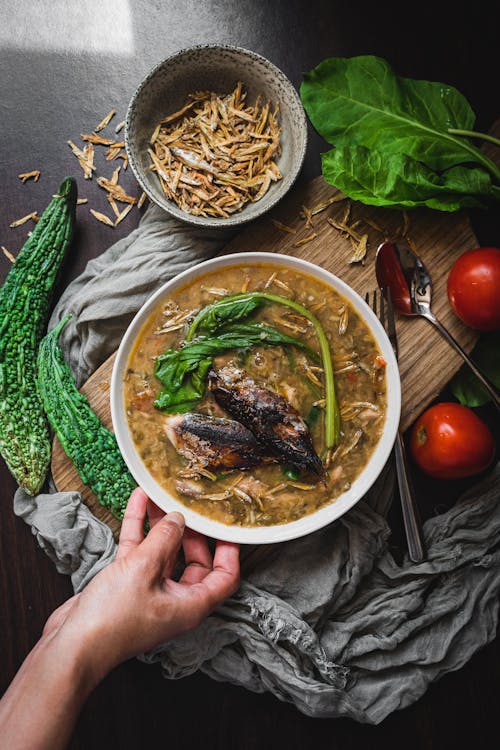 Person Holding White Ceramic Bowl With Food