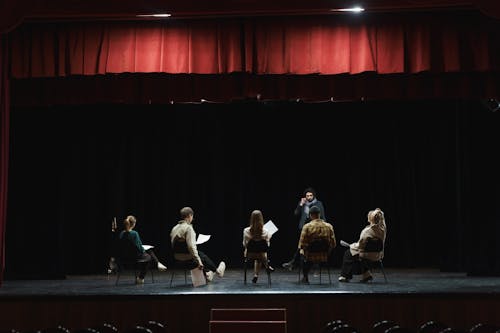 Free Group of People Sitting on Chair on Stage Stock Photo