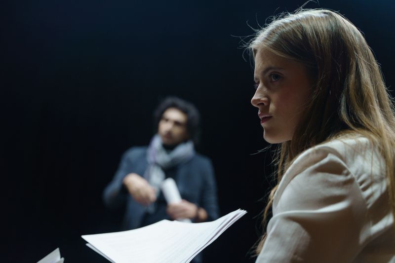 Student rehearsing a monologue with full expression and focus