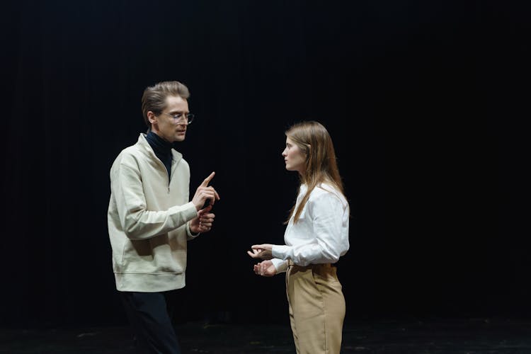 Man In White Shirt Standing Beside Woman 