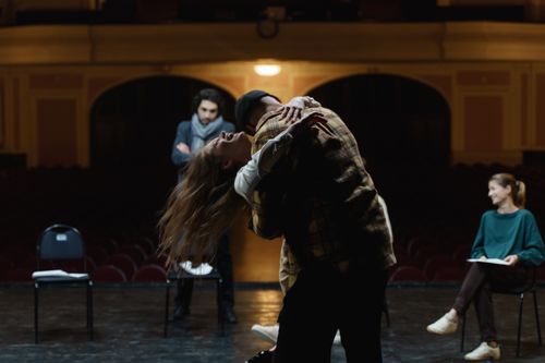 Free Actors in a dramatic rehearsal on a theater stage, showcasing emotion and performance. Stock Photo