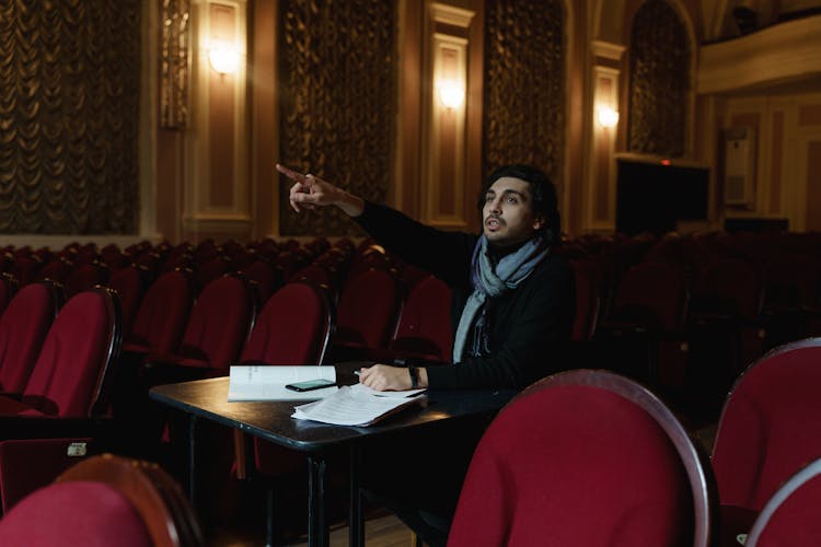 Man Sitting On A Chair Giving Instruction