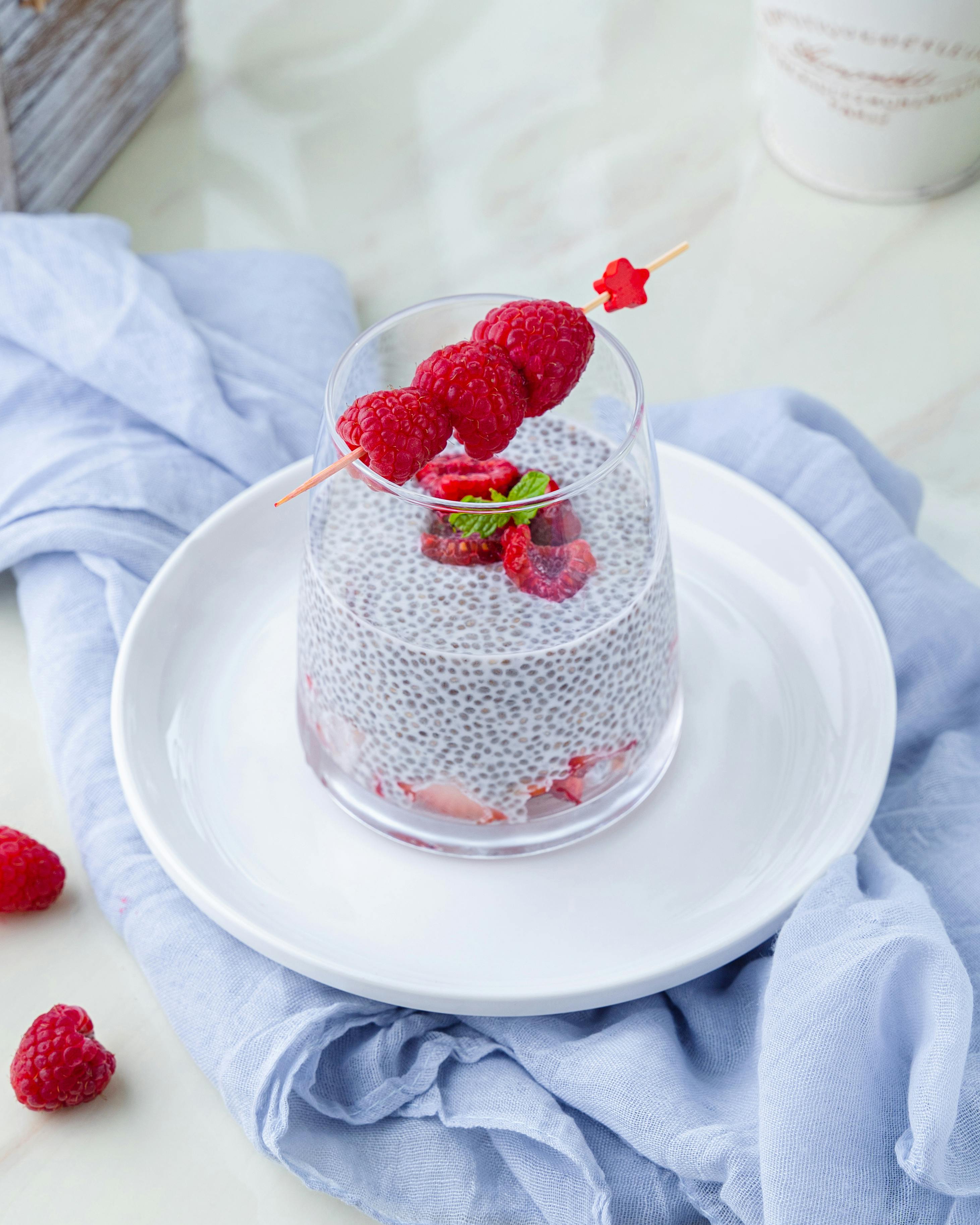 Refreshing chia pudding topped with raspberries and mint. Ideal for a healthy breakfast.