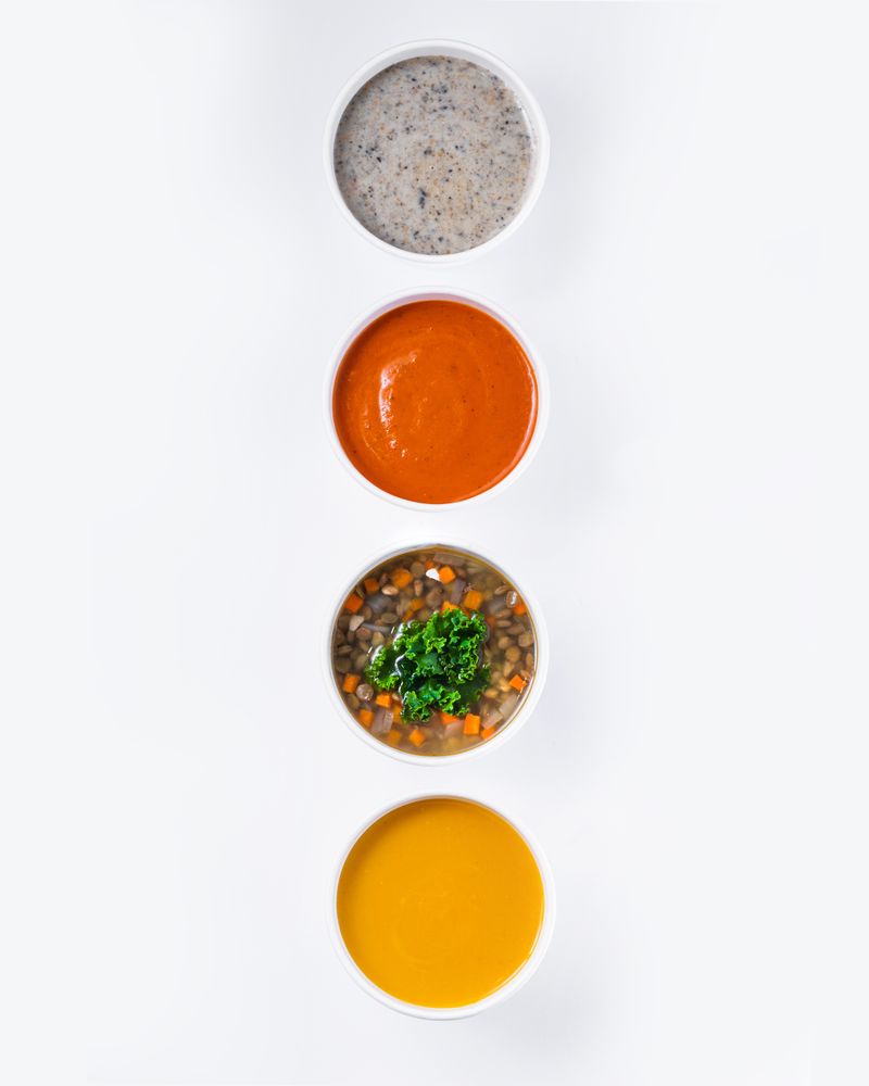 Assorted soups in white bowls