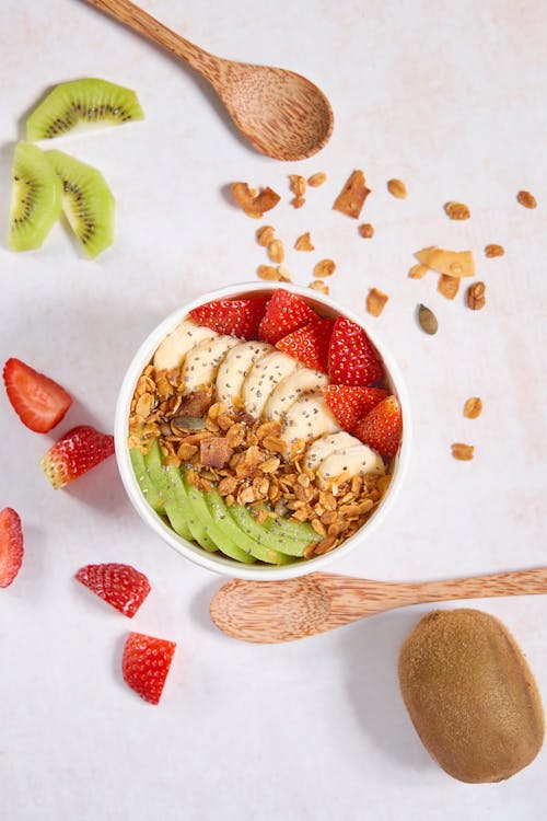 Free Slices of Delicious Mixed Fruits with Nuts and Flax Seeds in a Bowl Stock Photo